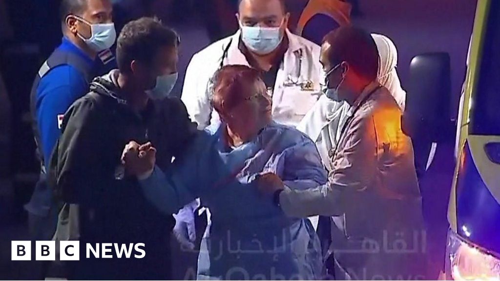 Israel hostages: Freed woman helped out of ambulance